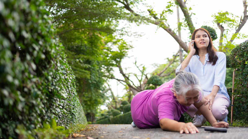 Asian senior woman fell down on lying floor because faint and limb weakness and pain from accident and woman came to help support and call emergency