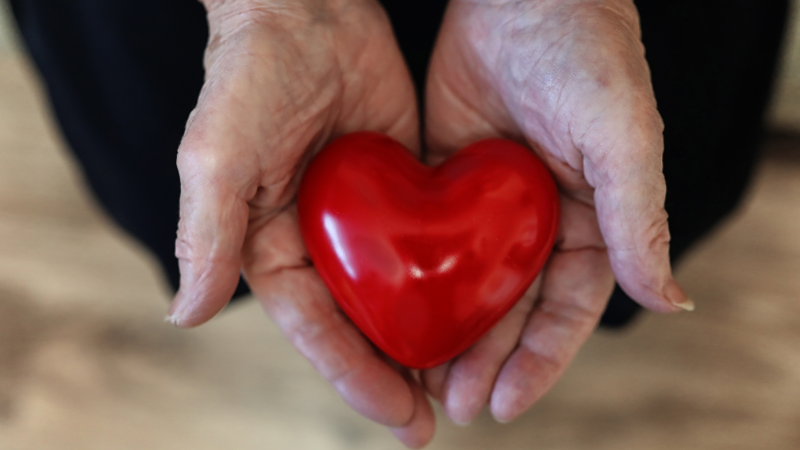 Elder Woman Holding Heart